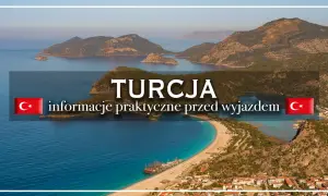 Piękna zatoka i góry w Turcji. Morze zachwyca turkusowym kolorem, a na plaży widać łodzie.